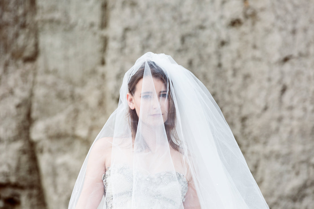 Brider underneath a bridal blusher veil
